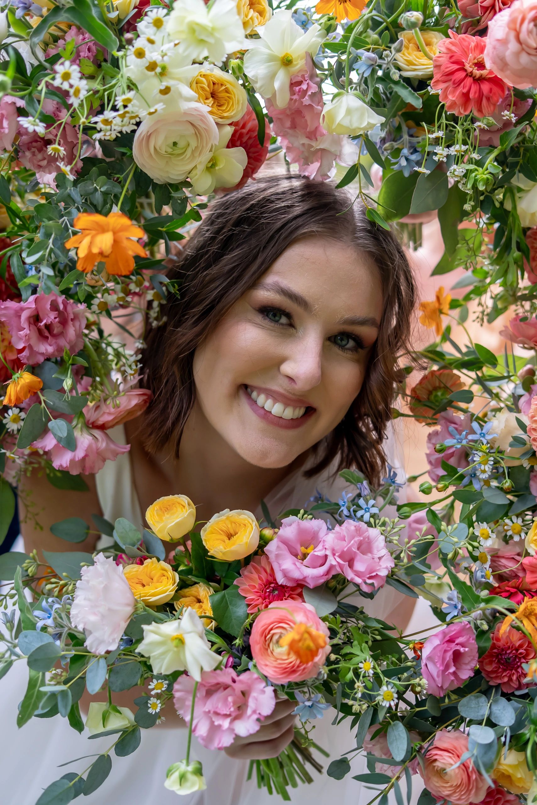 Woman framed by vibrant floral arrangement