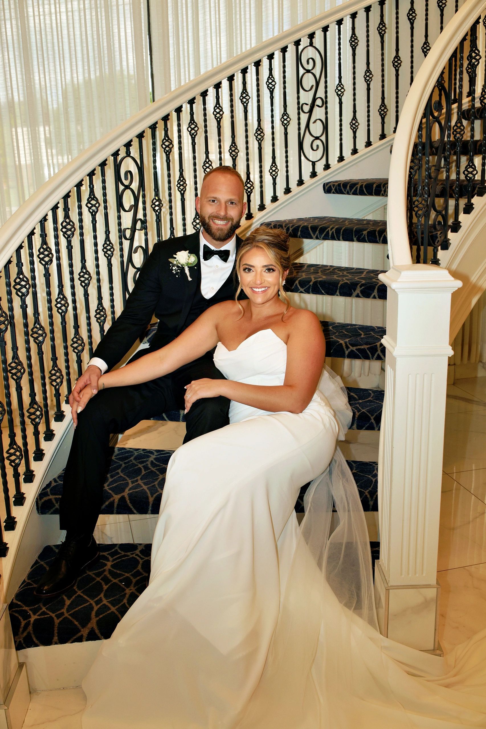 Bride and groom on ornate staircase